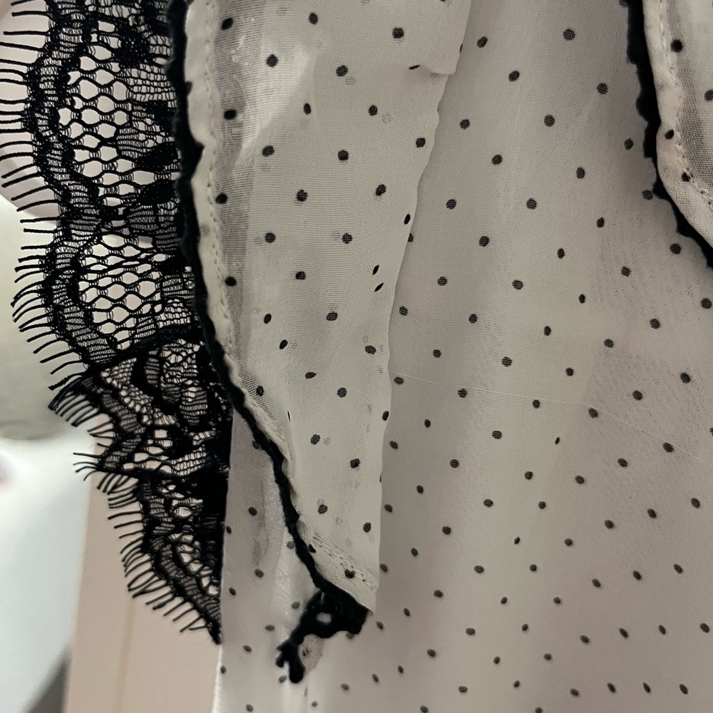Size 8 blank and white Polka dot dressy top.